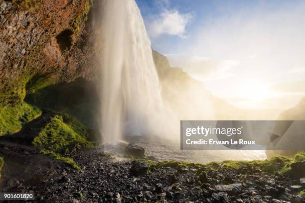 a famous icelandic landscape : seljalandsfoss waterfall during the golden hour before sunset - cliff side stock pictures, royalty-free photos & images