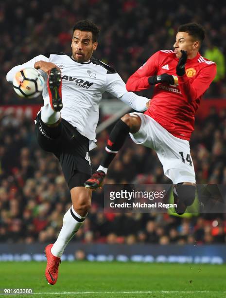 Tom Huddlestone of Derby County jumps for the ball with Jesse Lingard of Manchester United during the Emirates FA Cup Third Round match between...