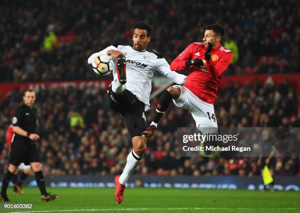 Tom Huddlestone of Derby County jumps for the ball with Jesse Lingard of Manchester United during the Emirates FA Cup Third Round match between...