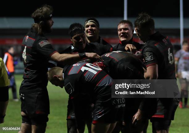 Grant Gilchrist of Edinburgh Rugby is congratulated by team mates after he scores his side's first try during the Guinness Pro14 match between...