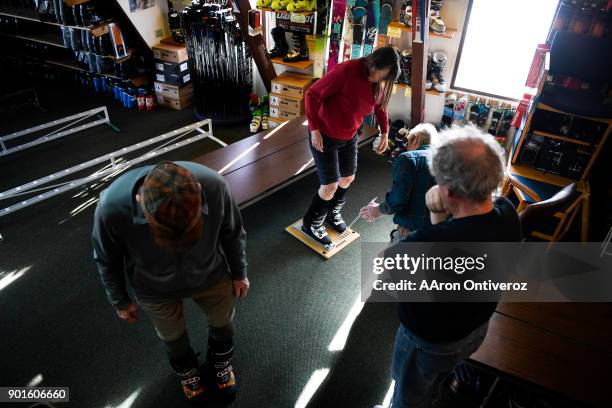 Irena Wilder and her husband, J.W. Are fitted for custom ski boots by Scott Fisher and owner Tracy Smith at Mt. Shavano Ski & Snowboard Shop on...