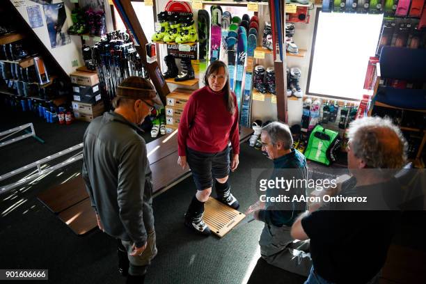 Irena Wilder and her husband, J.W. Are fitted for custom ski boots by Scott Fisher and owner Tracy Smith at Mt. Shavano Ski & Snowboard Shop on...