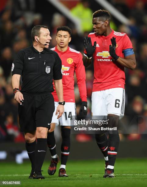 Referee Kevin Friend and Paul Pogba of Manchester United in discussion during the Emirates FA Cup Third Round match between Manchester United and...