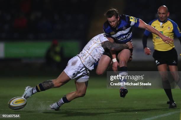 Chris Cook of Bath kicks on as Francois Hougaard of Worcester makes the tackle during the Aviva Premiership match between Worcester Warriors and Bath...