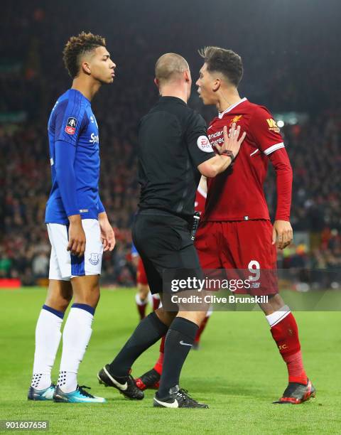 Referee Robert Madley intervenes as Mason Holgate of Everton and Roberto Firmino of Liverpool clash during the Emirates FA Cup Third Round match...