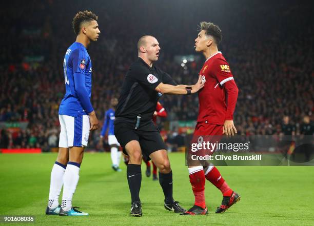 Referee Robert Madley intervenes as Mason Holgate of Everton and Roberto Firmino of Liverpool clash during the Emirates FA Cup Third Round match...