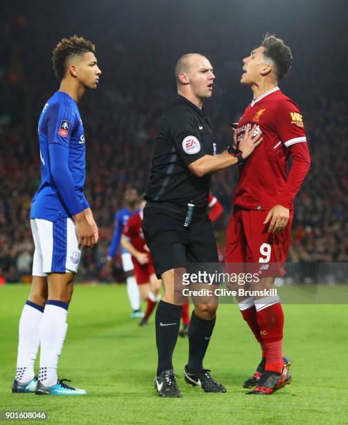 Referee Robert Madley intervenes as Mason Holgate of Everton and Roberto Firmino of Liverpool clash during the Emirates FA Cup Third Round match...