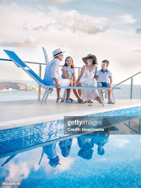 family by poolside enjoying - rooftop pool imagens e fotografias de stock