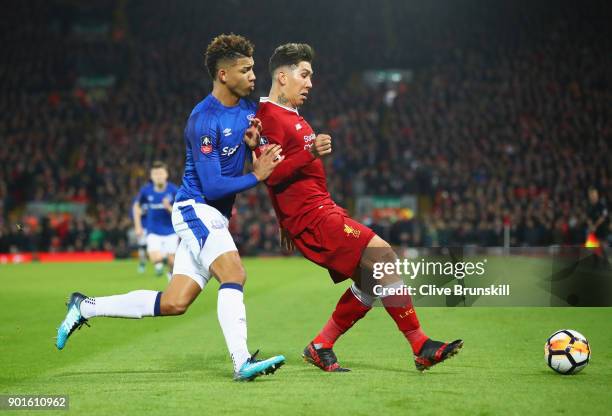 Roberto Firmino of Liverpool and Mason Holgate of Everton tussle for the ball during the Emirates FA Cup Third Round match between Liverpool and...