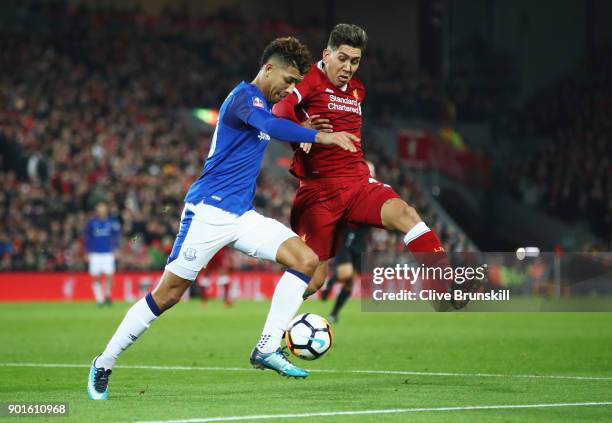 Roberto Firmino of Liverpool and Mason Holgate of Everton battle for the ball during the Emirates FA Cup Third Round match between Liverpool and...