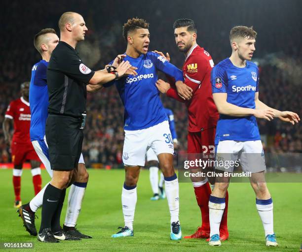 Mason Holgate of Everton is restrained by referee Robert Madley after a clash with Roberto Firmino of Liverpool during the Emirates FA Cup Third...