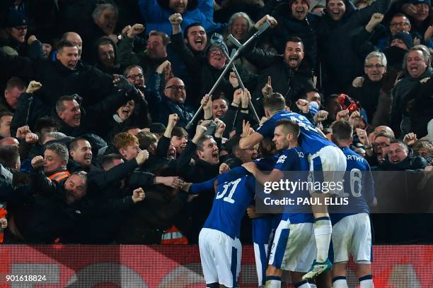 Everton players celebrate with the crowd after Everton's Icelandic midfielder Gylfi Sigurdsson scored their first goal to equalise 1-1 during the...