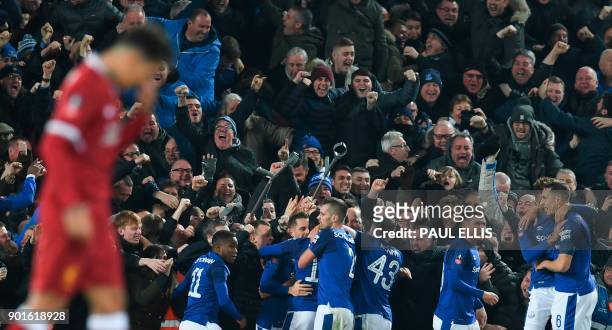 Everton players celebrate with the crowd after Everton's Icelandic midfielder Gylfi Sigurdsson scored their first goal to equalise 1-1 during the...