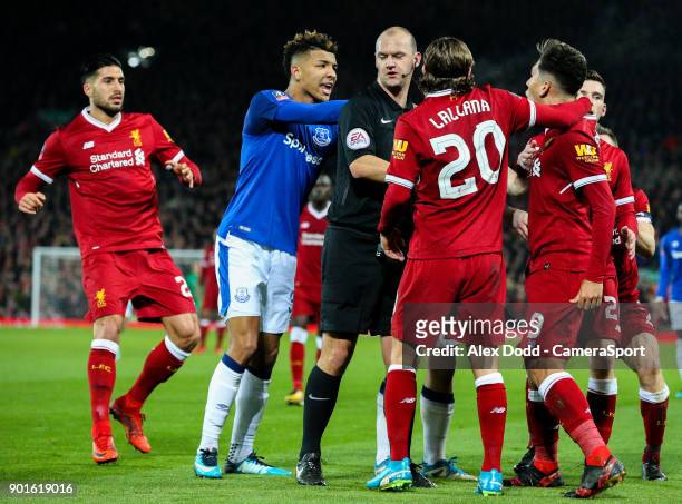 Everton's Mason Holgate and Liverpool's Roberto Firmino have an altercation while referee Robert Madley tries to separate the pair during the...