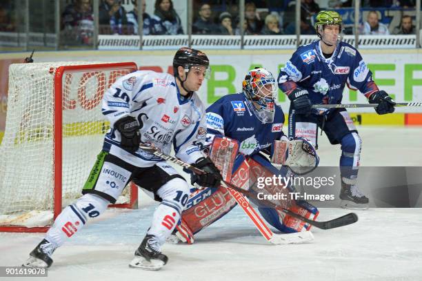 Kyle MacKinnon of Straubing, Goalkeeper Sebastian Dahm of Iserlohn and Alexander Bonsanksen of Iserlohn in action during the DEL match between...