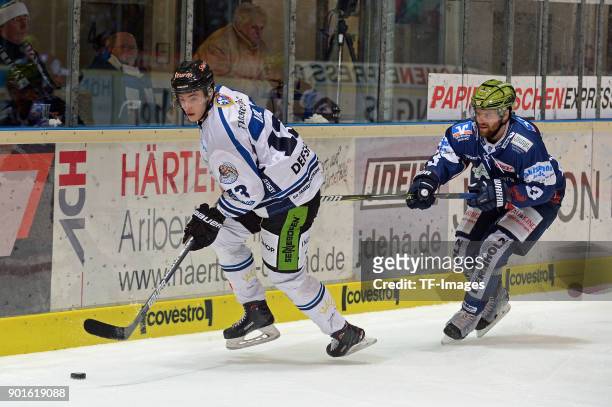Stefan Loibl of Straubing and Johan Larsson of Iserlohn battle for the ball during the DEL match between Iserlohn Roosters and Straubing Tigers at...