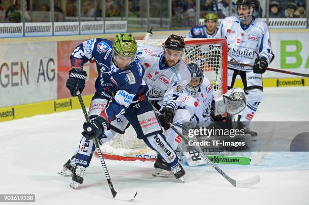 Jason Jaspers of Iserlohn and Colton Jobke of Straubing battle for the ball during the DEL match between Iserlohn Roosters and Straubing Tigers at...