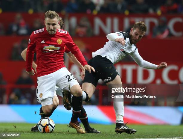 Luke Shaw of Manchester United in action with Andreas Weimann of Derby County during the Emirates FA Cup Third Round match between Manchester United...