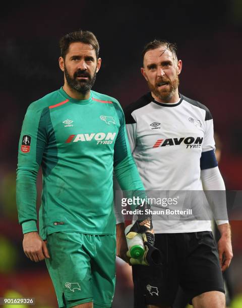 Scott Carson and Richard Keogh of Derby County look dejected in defeat after the Emirates FA Cup Third Round match between Manchester United and...