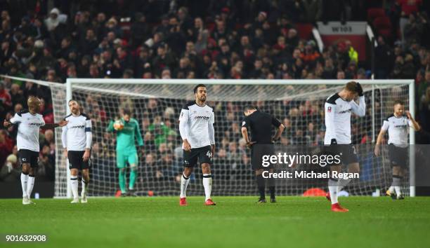 Tom Huddlestone of Derby County and team mates look dejected during the Emirates FA Cup Third Round match between Manchester United and Derby County...