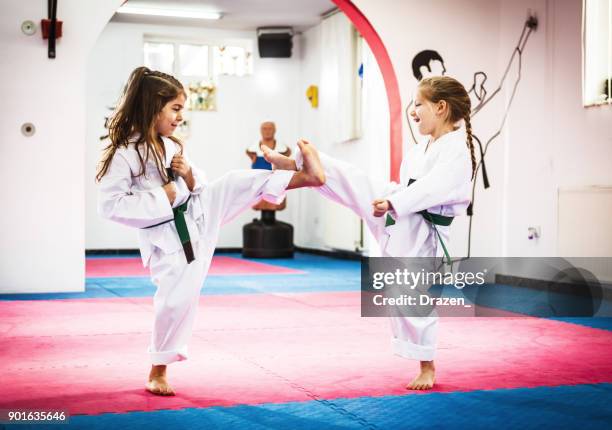 cute girls on taekwondo training - taekwondo stock pictures, royalty-free photos & images