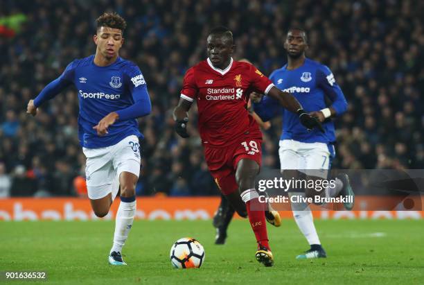 Sadio Mane of Liverpool is chased by Mason Holgate and Yannick Bolasie during the Emirates FA Cup Third Round match between Liverpool and Everton at...