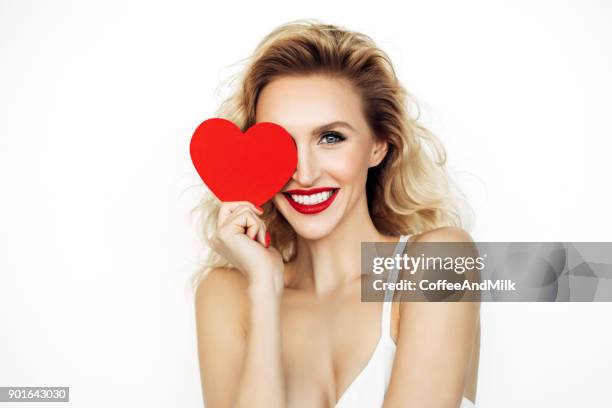 beautiful woman holding artificial heart - lipstick heart stock pictures, royalty-free photos & images