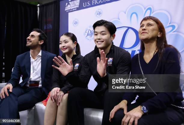 Coachs Massimo Scali and Marina Zueva waits for their score in the kiss and cry with Maia Shibutani and Alex Shibutani after they competed in the...