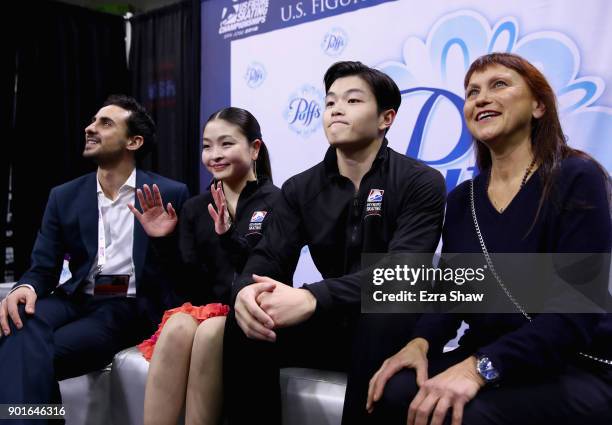 Coachs Massimo Scali and Marina Zueva waits for their score in the kiss and cry with Maia Shibutani and Alex Shibutani after they competed in the...