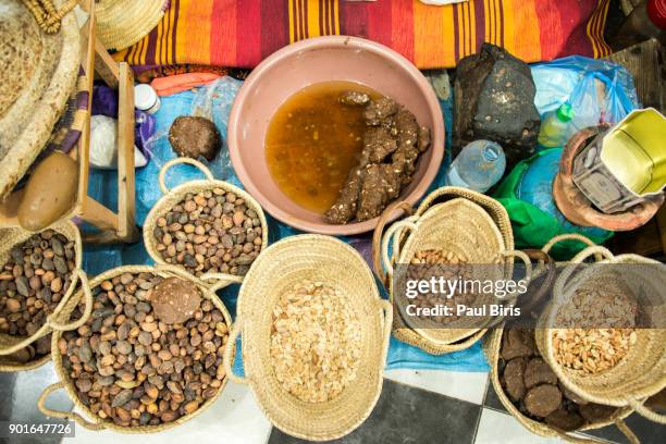 traditional argan oil production work place with stone mill, taroudant, morocco - argan oil stock pictures, royalty-free photos & images