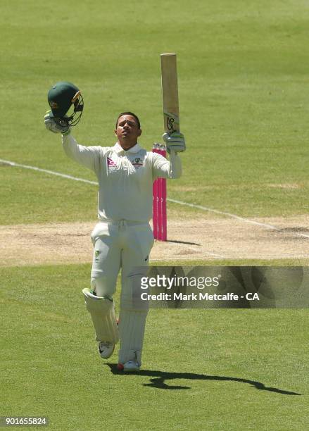 Usman Khawaja of Australia celebrates and acknowledges the crowd after scoring a century during day three of the Fifth Test match in the 2017/18...