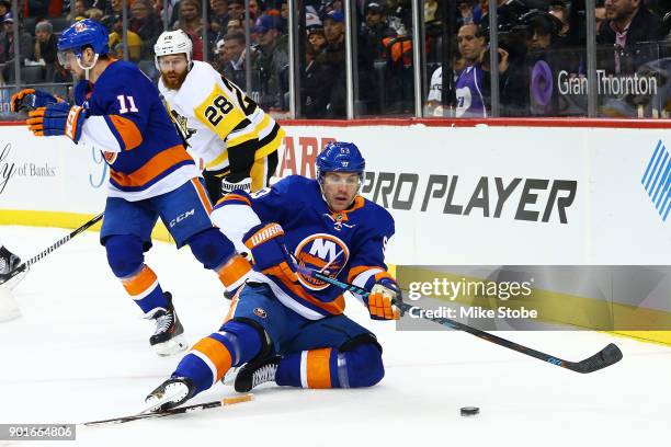 Casey Cizikas of the New York Islanders plays the puck during the first period after tripping over a stick dropped by teammate Shane Prince at...