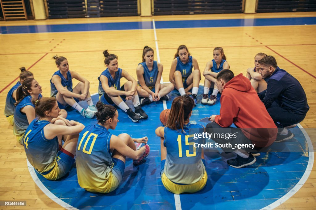 Coach talking to a young basketball players