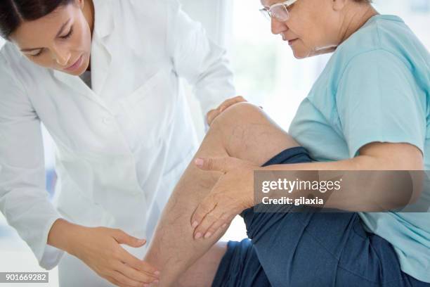 senior woman in a massage treatment. - legs woman stock pictures, royalty-free photos & images