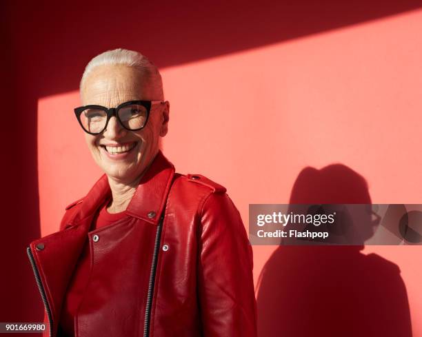 portrait of confident mature woman - red eyeglasses stock pictures, royalty-free photos & images