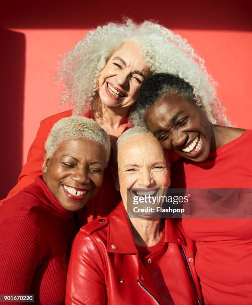 group portrait of four women - diverse mature women stock pictures, royalty-free photos & images