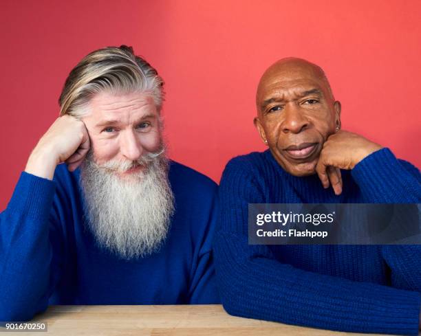 portrait of two mature men - opposites stock-fotos und bilder