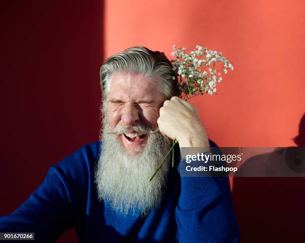 Portrait of man holding flowers