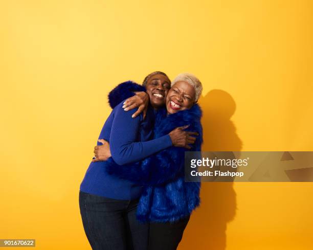 portrait of two mature women dancing and having fun together - embracing stock pictures, royalty-free photos & images