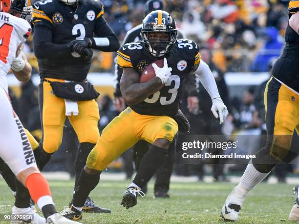 Running back Fitzgerald Toussaint of the Pittsburgh Steelers carries the ball downfield in the second quarter of a game on December 31, 2017 against...