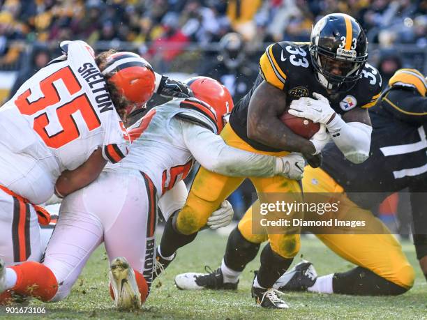 Running back Fitzgerald Toussaint of the Pittsburgh Steelers is tackled by linebacker James Burgess Jr. #52 of the Cleveland Browns in the second...