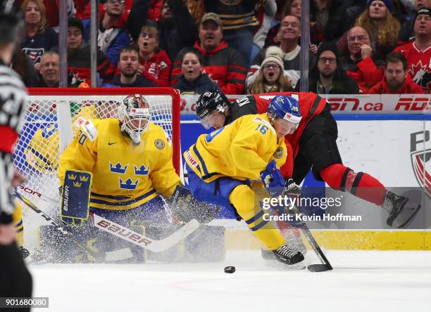 Linus Lindstrm of Sweden goes after a rebound in front of Filip Gustavsson in the second period against Canada during the Gold medal game of the IIHF...