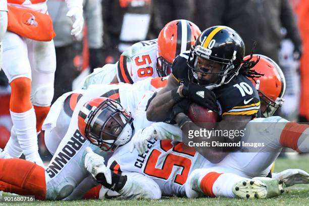 Wide receiver Martavis Bryant of the Pittsburgh Steelers is tackled by linebackers Christian Kirksey, James Burgess Jr. #52 and defensive back Derron...