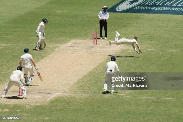 Mason Crane of England dives for a ball from Shaun Marsh of Australia during day three of the Fifth Test match in the 2017/18 Ashes Series between...