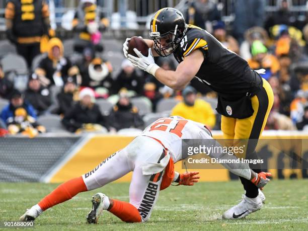 Tight end Jesse James of the Pittsburgh Steelers is tackled by cornerback Jamar Taylor of the Cleveland Browns in the fourth quarter of a game on...