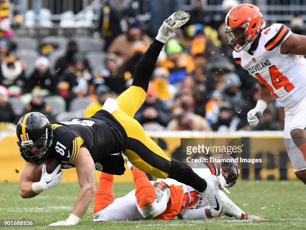 Tight end Jesse James of the Pittsburgh Steelers is tackled by cornerback Jamar Taylor of the Cleveland Browns in the fourth quarter of a game on...