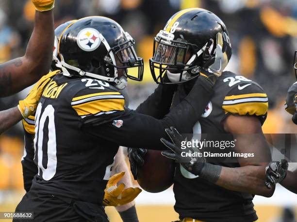 Safety Sean Davis of the Pittsburgh Steelers celebrates intercepting a pass with safety Robert Golden in the fourth quarter of a game on December 31,...
