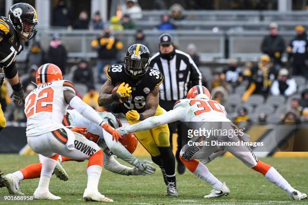 Running back Stevan Ridley of the Pittsburgh Steelers is tackled by linebacker James Burgess Jr. #52, cornerback Jason McCourty and safety Jabrill...