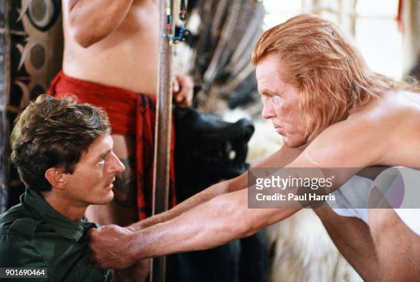 Nick Nolte as Learoyd stares at Nigel Havers as Captain Fairbourne during the filming of Farewell to The King August 1987 in Sarawak, Borneo,...