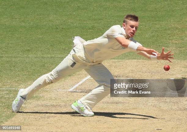 Mason Crane of England fields off his own bowling during day three of the Fifth Test match in the 2017/18 Ashes Series between Australia and England...